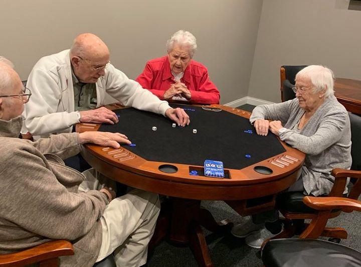 elders enjoying playing board games